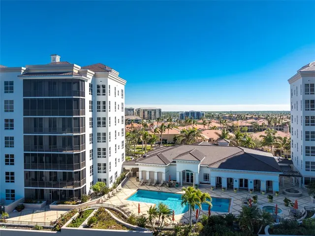 a outdoor space with lots of tables a large window and chairs