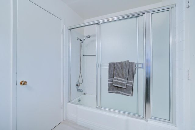 a bathroom with a shower and a tub