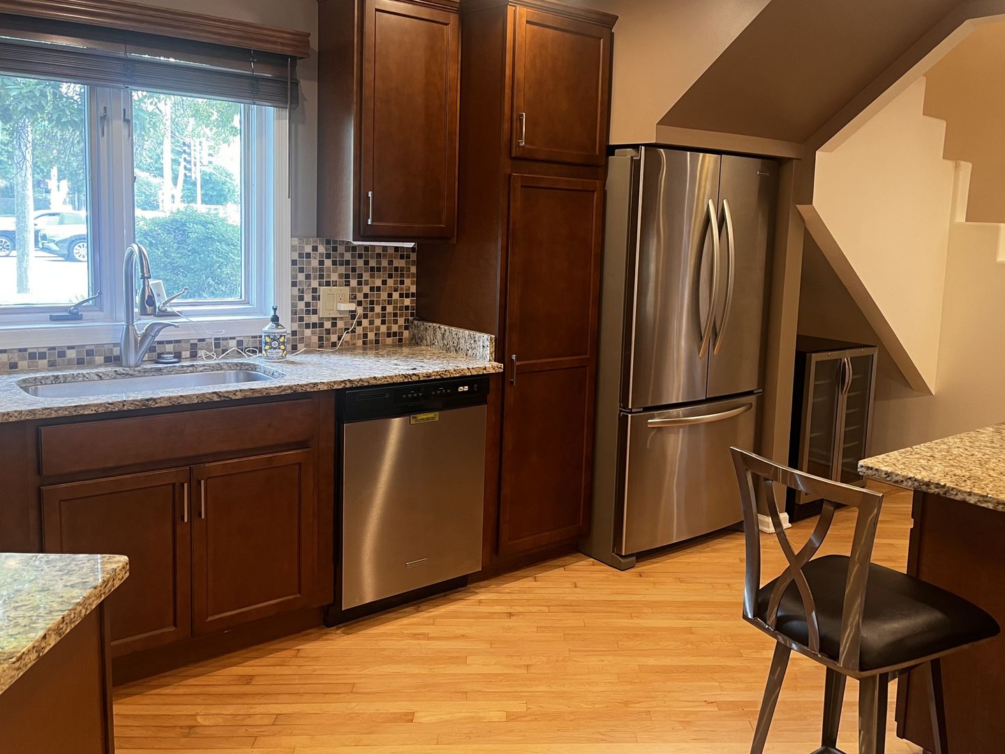 414 South Dee Road Park Ridge, IL 60068 - Photo 4 of 37 a kitchen with stainless steel appliances granite countertop a refrigerator a sink dishwasher a stove with white cabinets and wooden floor