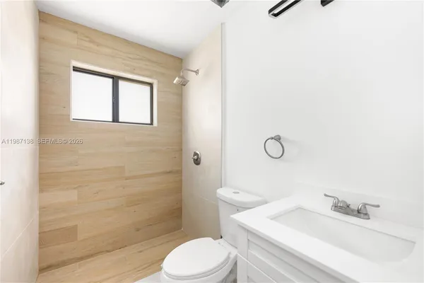 a bathroom with a sink toilet and shower