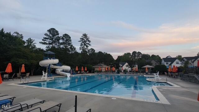 3541 Fairstone Road Wake Forest, NC 27587 - Photo 37 of 39 a view of a swimming pool with a table and chairs