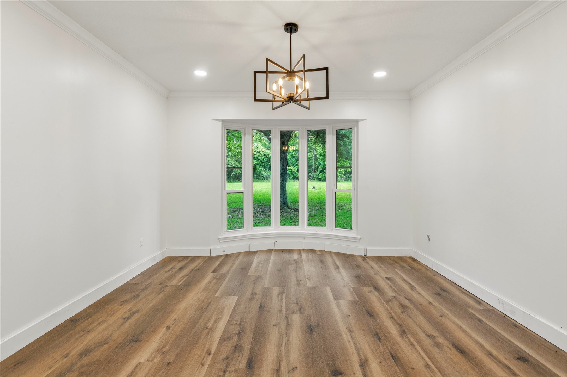74 Robinson Road Huntsville, TX 77320 - Photo 12 of 33 a view of an empty room with wooden floor and a window