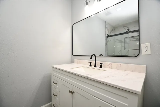 a bathroom with a sink and a mirror