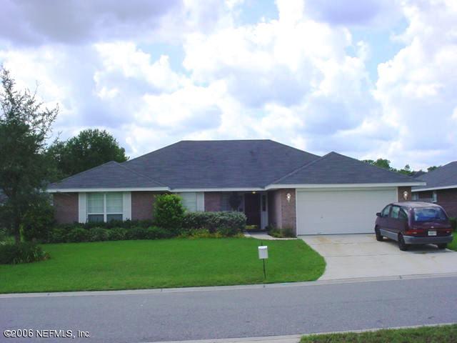 2498 Mallory Hills Road Jacksonville, FL 32221 - Photo 1 of 9 a front view of a house with a garden and entryway