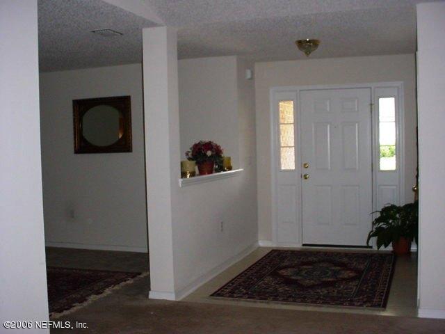 2498 Mallory Hills Road Jacksonville, FL 32221 - Photo 2 of 9 a view of a hallway with wooden floor and a living room