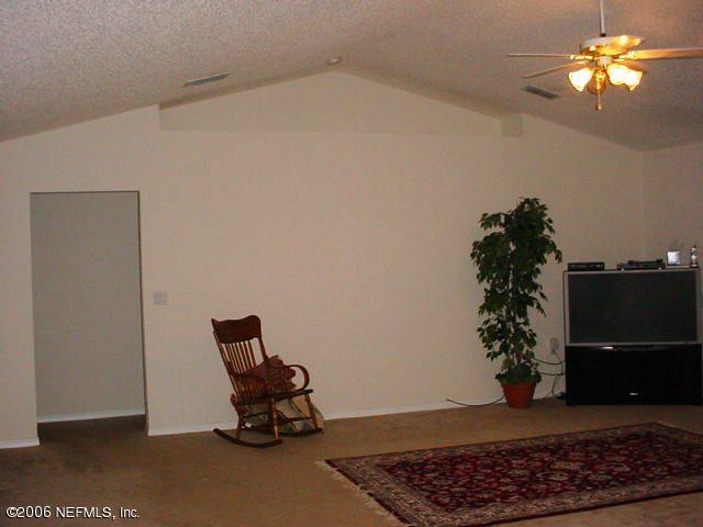 2498 Mallory Hills Road Jacksonville, FL 32221 - Photo 6 of 9 a room with wooden floor and a potted plant