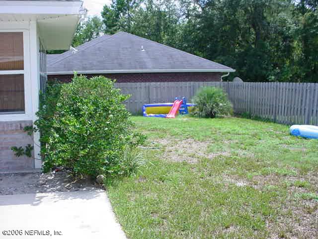 2498 Mallory Hills Road Jacksonville, FL 32221 - Photo 7 of 9 a aerial view of a house with yard and a garden