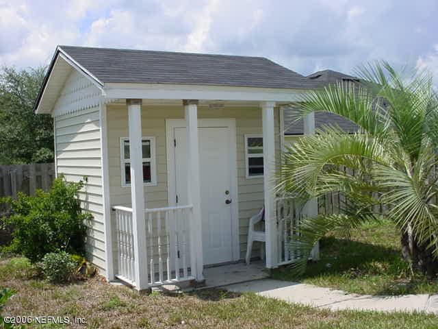 2498 Mallory Hills Road Jacksonville, FL 32221 - Photo 8 of 9 a view of a house with a small yard and plants