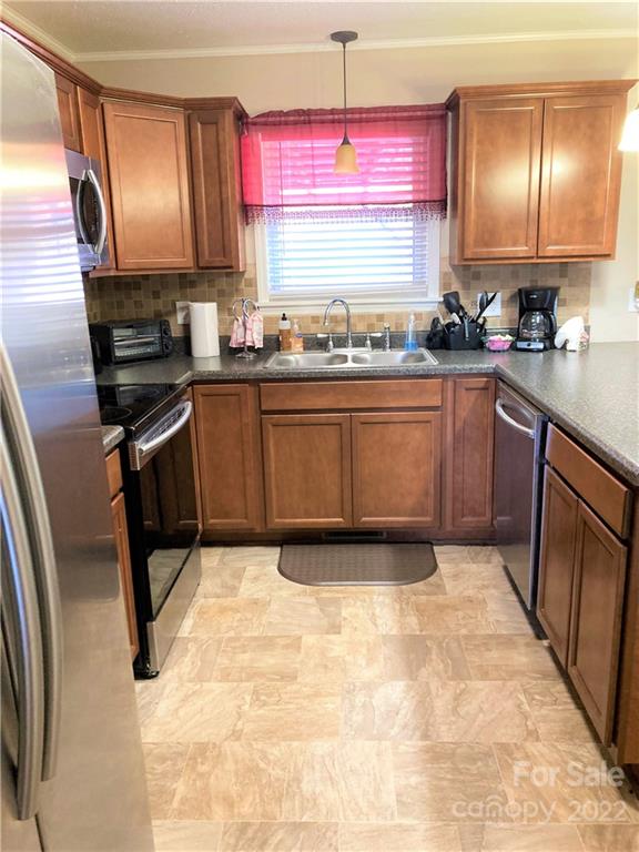 687 Thompson Road Rutherfordton, NC 28139 - Photo 8 of 38 a kitchen with stainless steel appliances granite countertop a stove a sink and a microwave