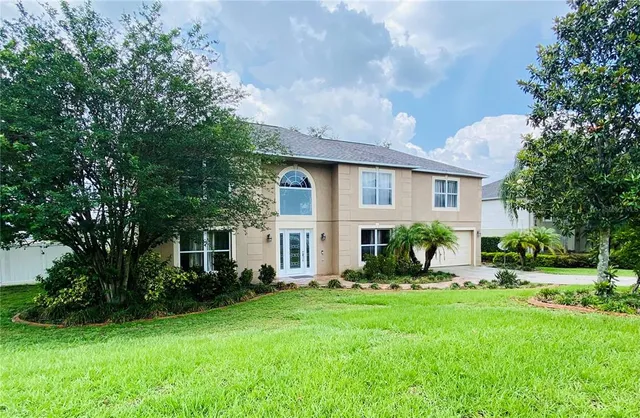 a front view of house with yard and green space