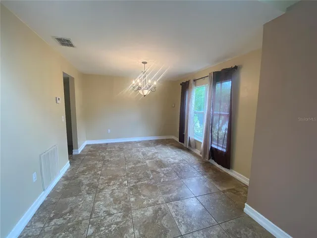 en empty room with a bathroom and mirror