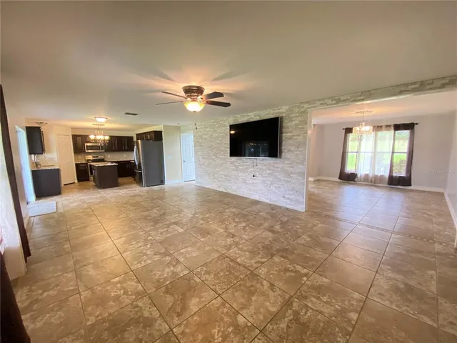 a view of kitchen with sink stove and refrigerator