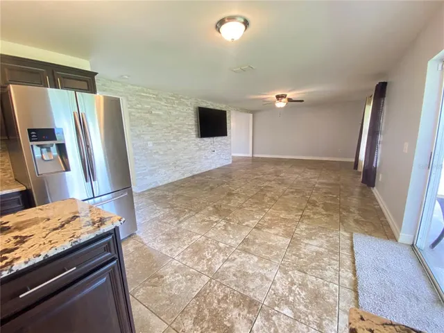 a kitchen with stainless steel appliances granite countertop a refrigerator and a sink