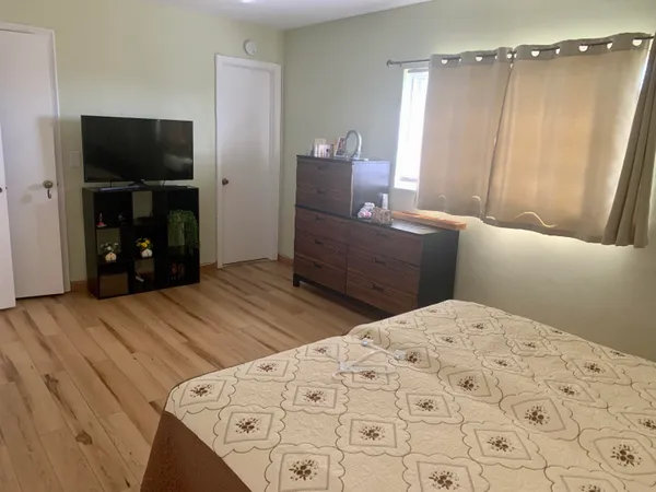 a bedroom with a bed and a television