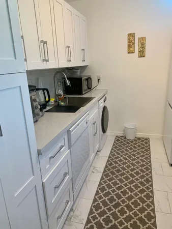 a kitchen with a sink and cabinets
