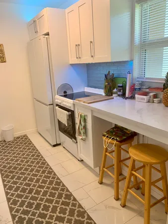 a kitchen with a sink a stove and a refrigerator