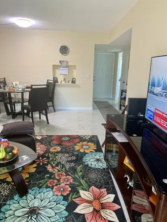 a living room with furniture and a dining table