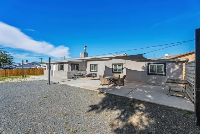 a view of a house with backyard patio and swimming pool