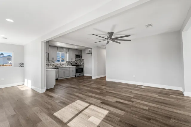 a view of a kitchen with a sink and a stove top oven