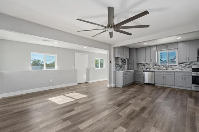 a view of a kitchen with a sink cabinets and wooden floor