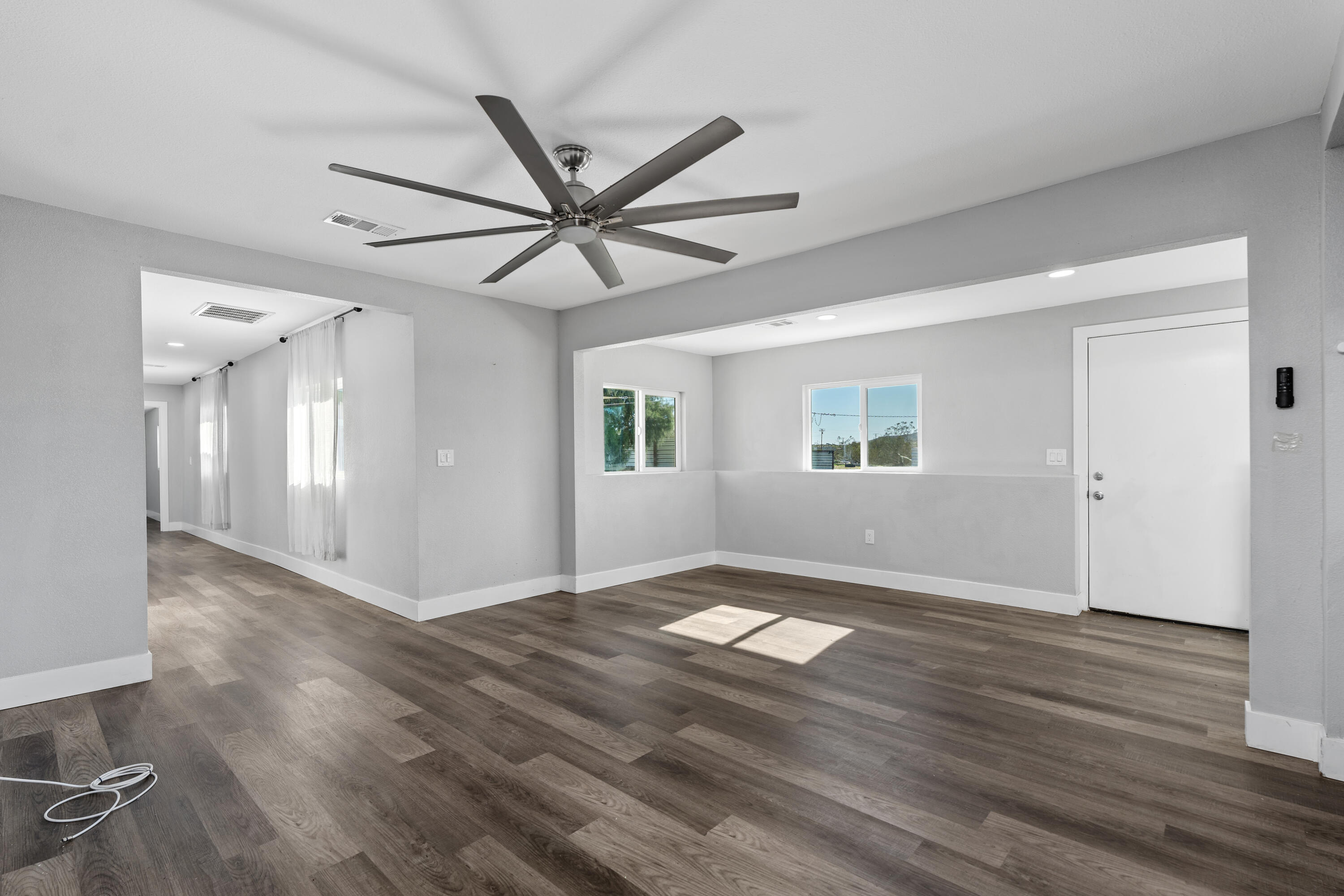 71362 Aurora Road Desert Hot Springs, CA 92241 - Photo 17 of 38 a view of an empty room with wooden floor and a window