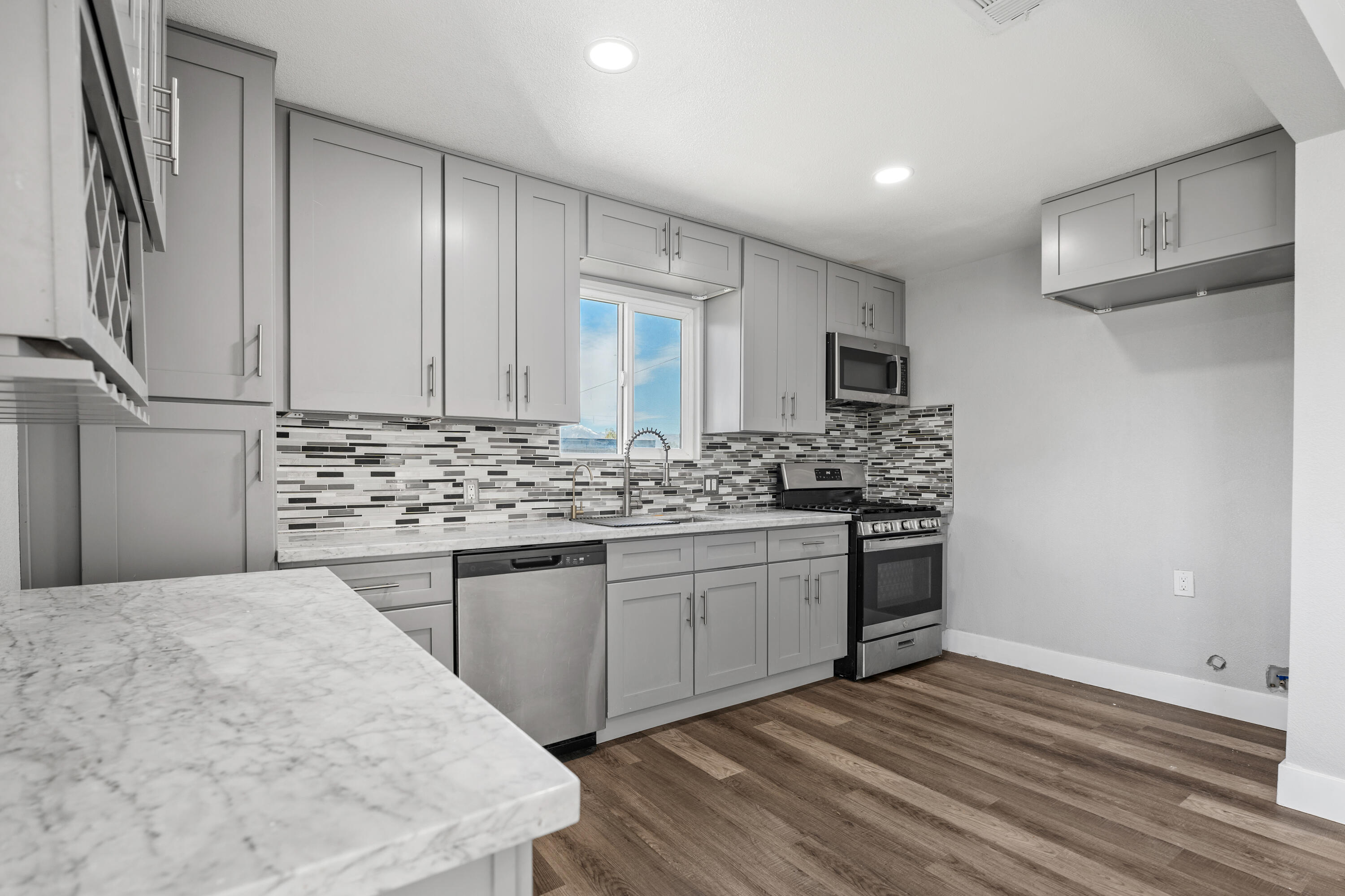71362 Aurora Road Desert Hot Springs, CA 92241 - Photo 18 of 38 a kitchen with stainless steel appliances kitchen island granite countertop a sink stove and refrigerator