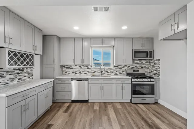 a kitchen with a sink stove and cabinets