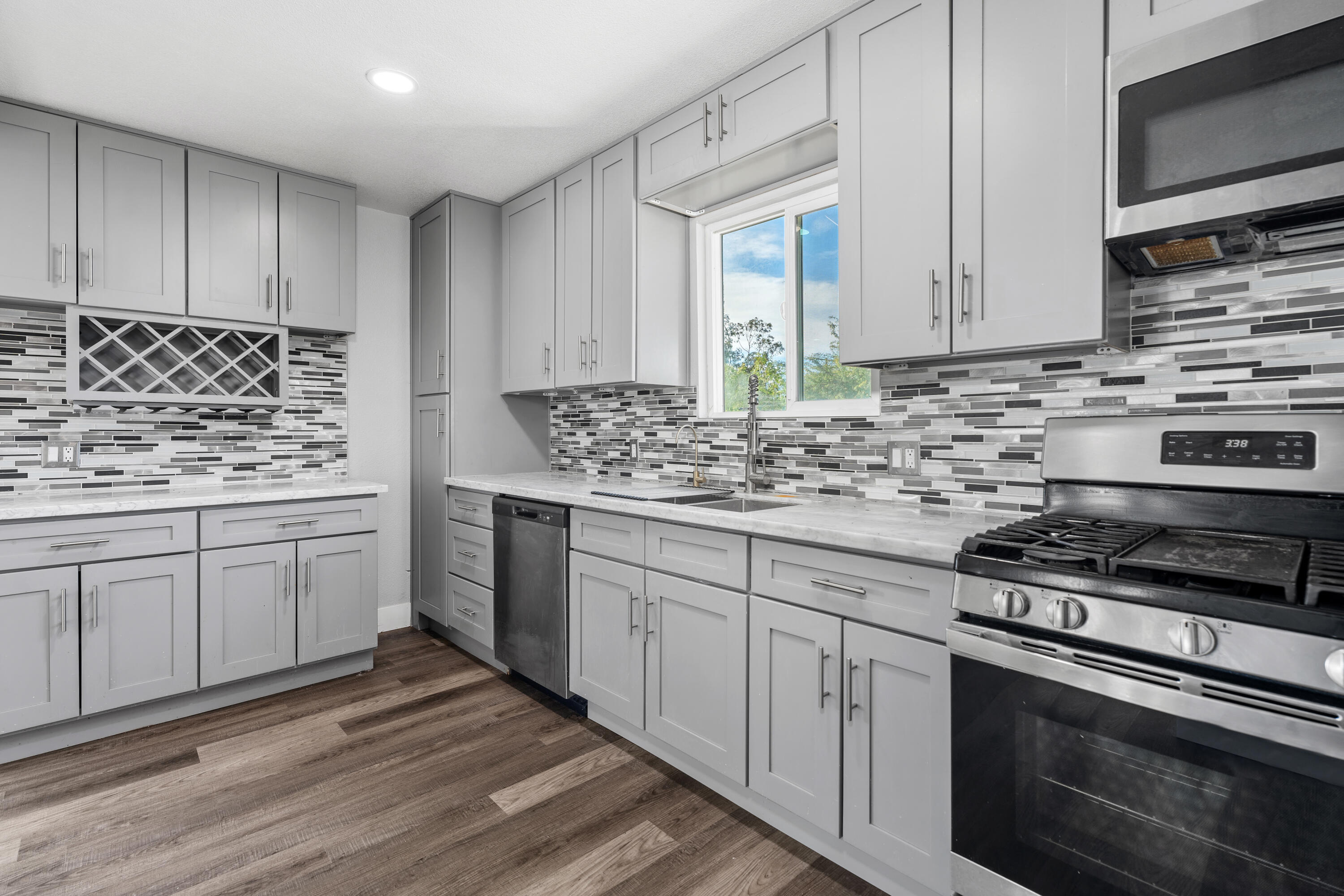 71362 Aurora Road Desert Hot Springs, CA 92241 - Photo 2 of 38 a kitchen with white cabinets and appliances