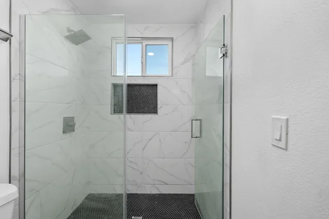 a bathroom with a shower and a sink