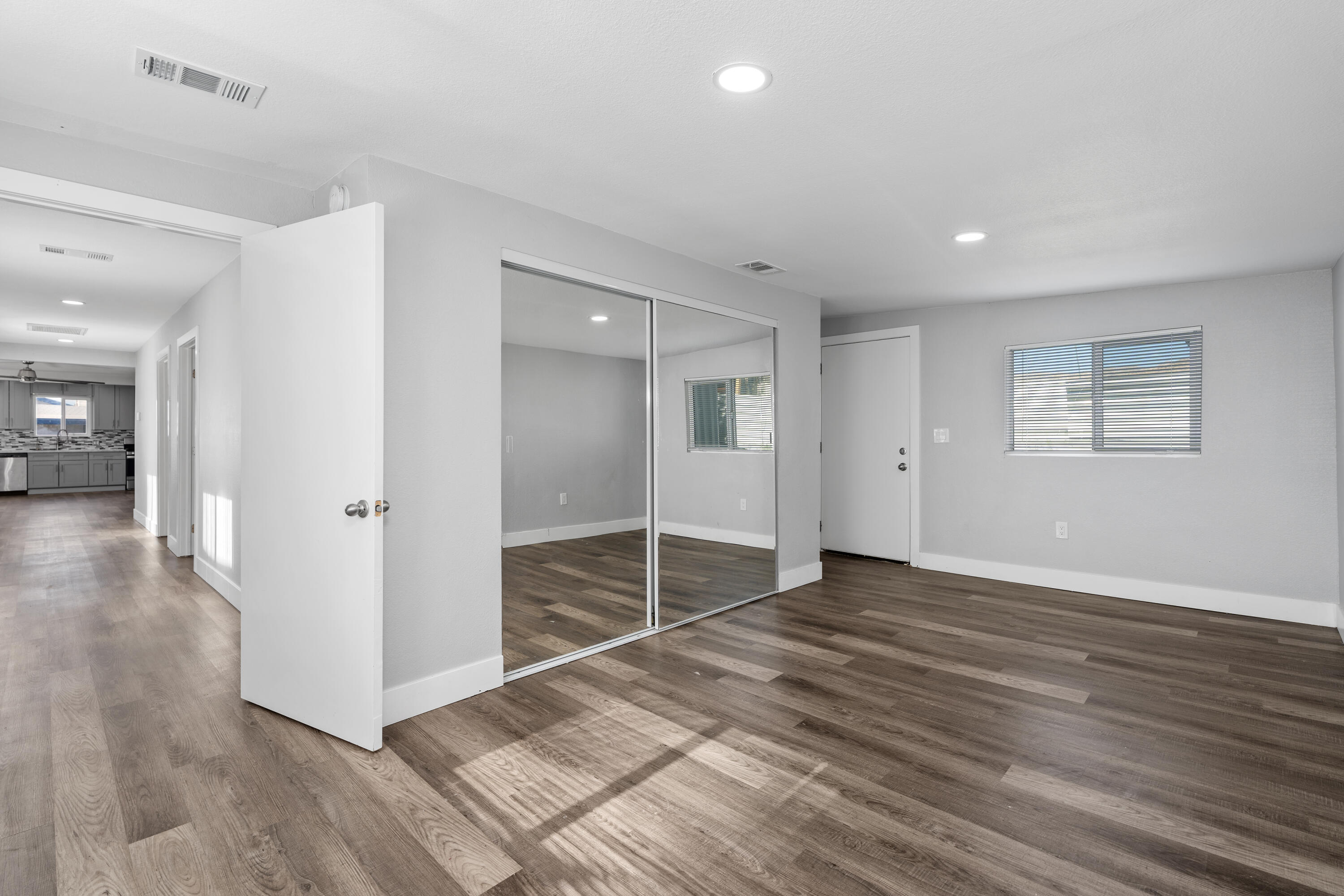 71362 Aurora Road Desert Hot Springs, CA 92241 - Photo 30 of 38 an empty room with wooden floor and windows