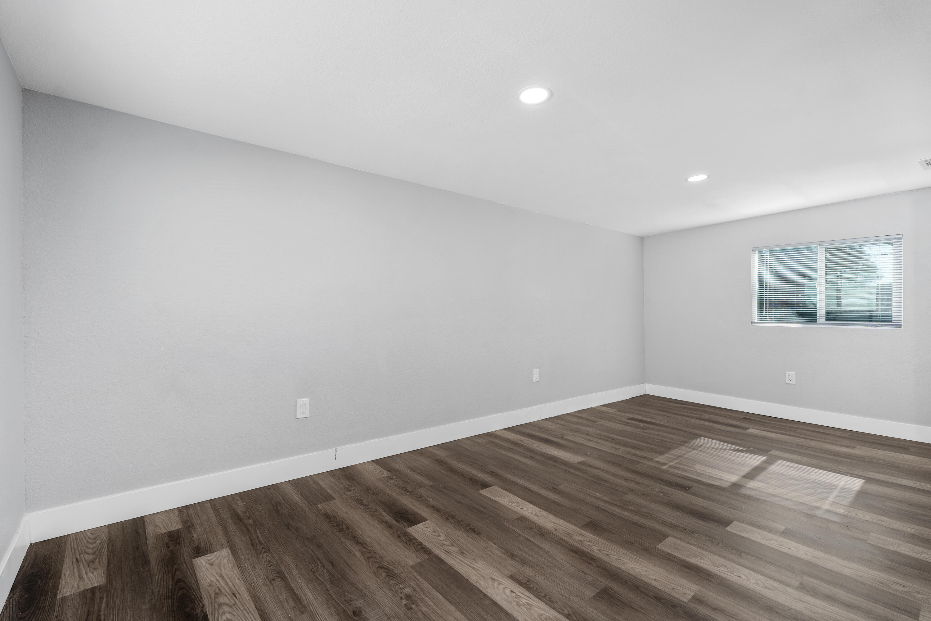 71362 Aurora Road Desert Hot Springs, CA 92241 - Photo 32 of 38 a view of an empty room with wooden floor and a window