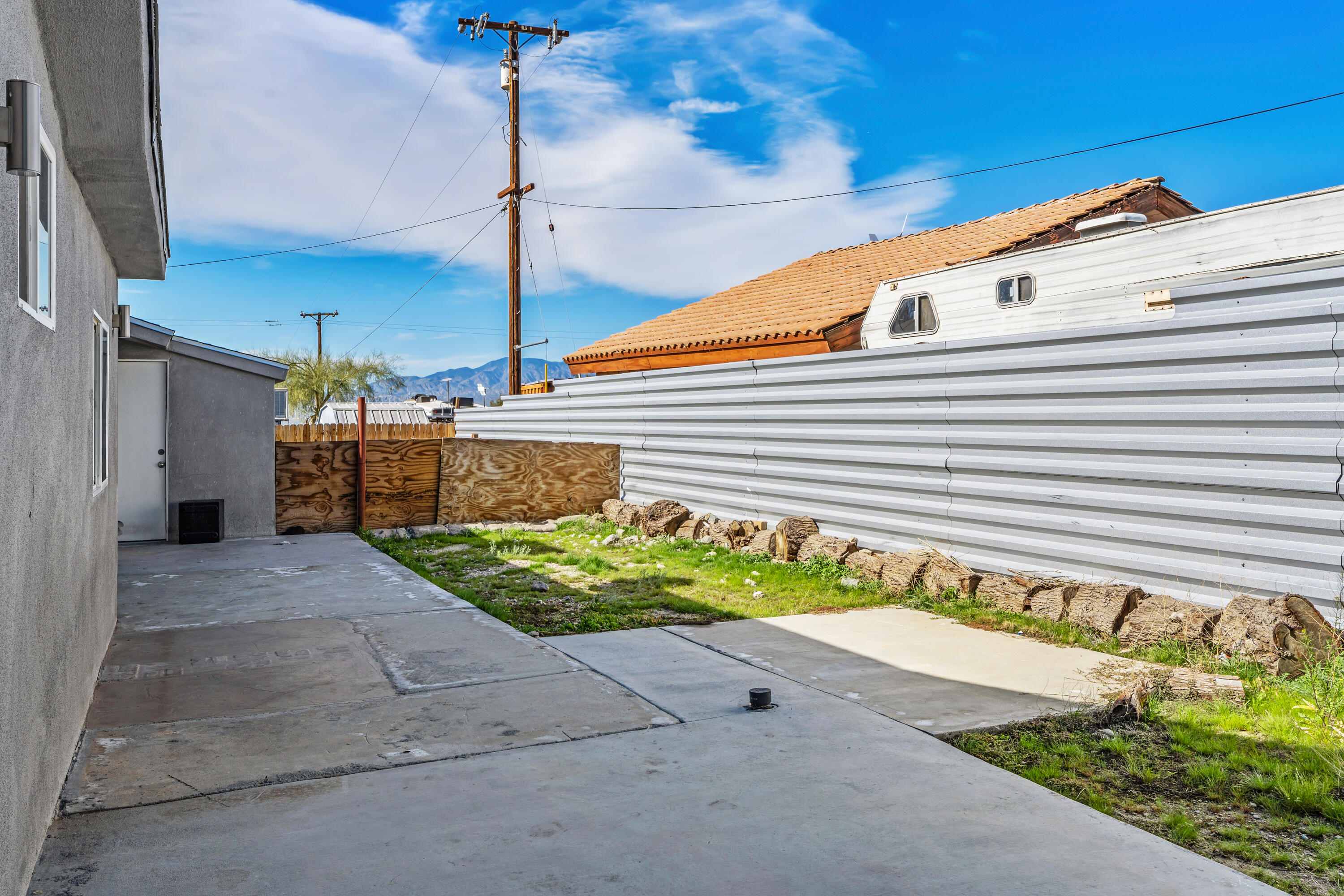 71362 Aurora Road Desert Hot Springs, CA 92241 - Photo 34 of 38 a front view of a house with a yard and a garage