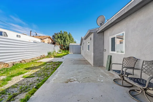 a view of a backyard with sitting area