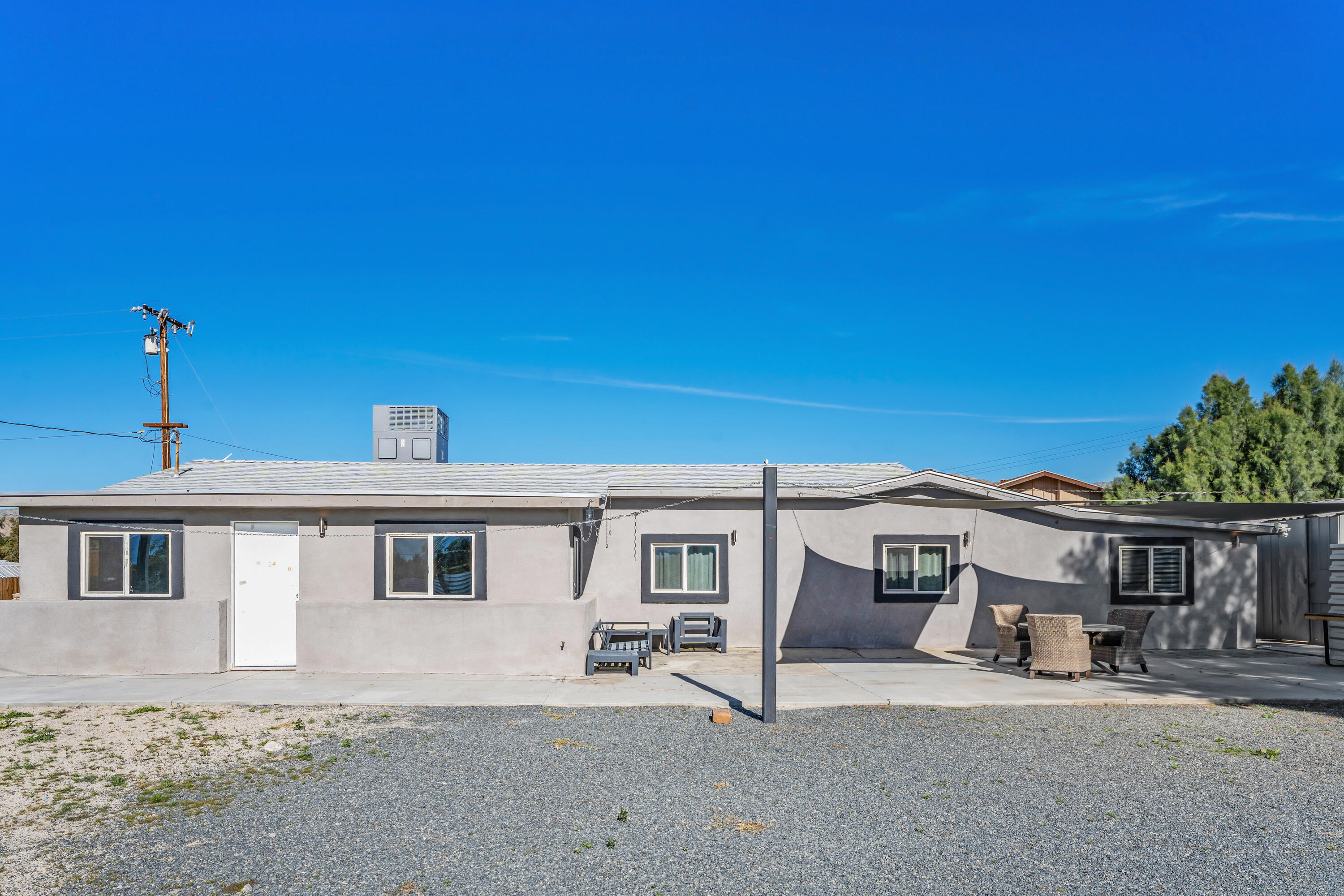 71362 Aurora Road Desert Hot Springs, CA 92241 - Photo 7 of 38 a front view of a house with a yard