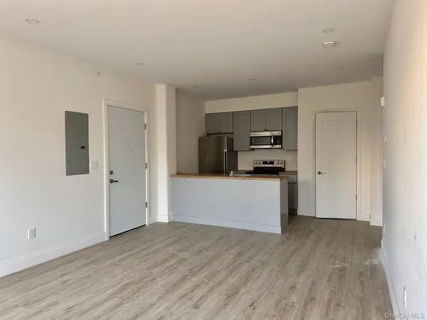 a kitchen with granite countertop a refrigerator and a stove top oven