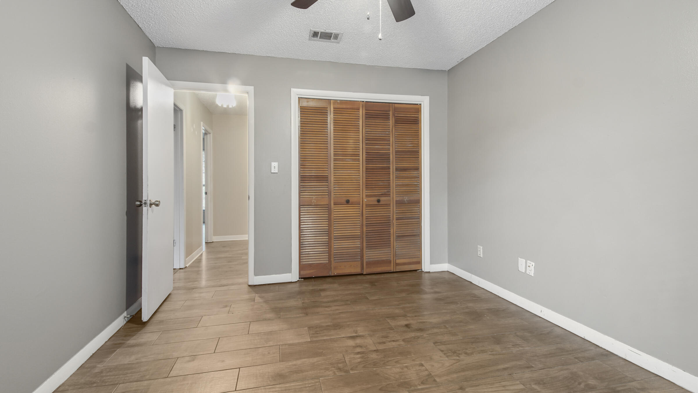5792 Wildwood Road Crestview, FL 32536 - Photo 22 of 43 an empty room with windows and closet