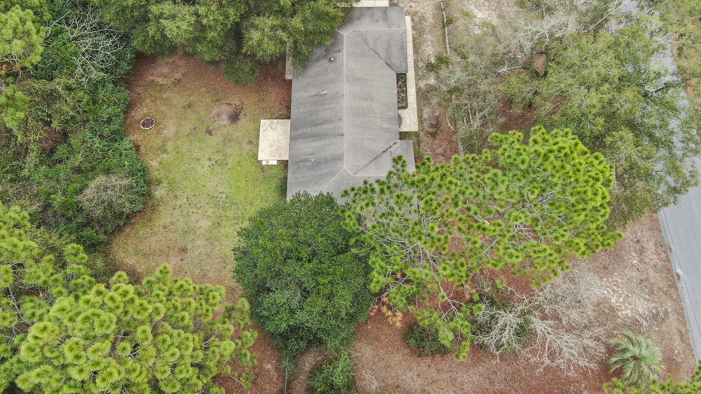 5792 Wildwood Road Crestview, FL 32536 - Photo 40 of 43 a backyard of a house with lots of green space