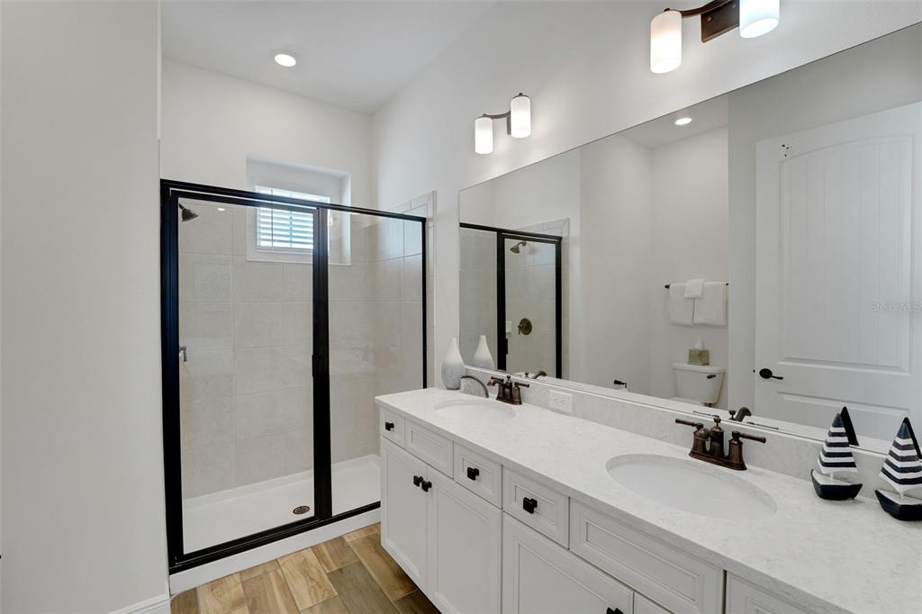 2968 Salted Rim Road Kissimmee, FL 34747 - Photo 14 of 86 a bathroom with a double vanity sink and mirror