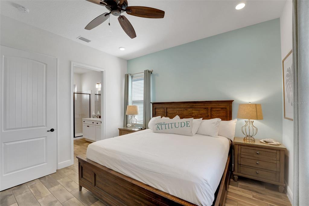 2968 Salted Rim Road Kissimmee, FL 34747 - Photo 16 of 86 a bedroom with a bed and a chandelier