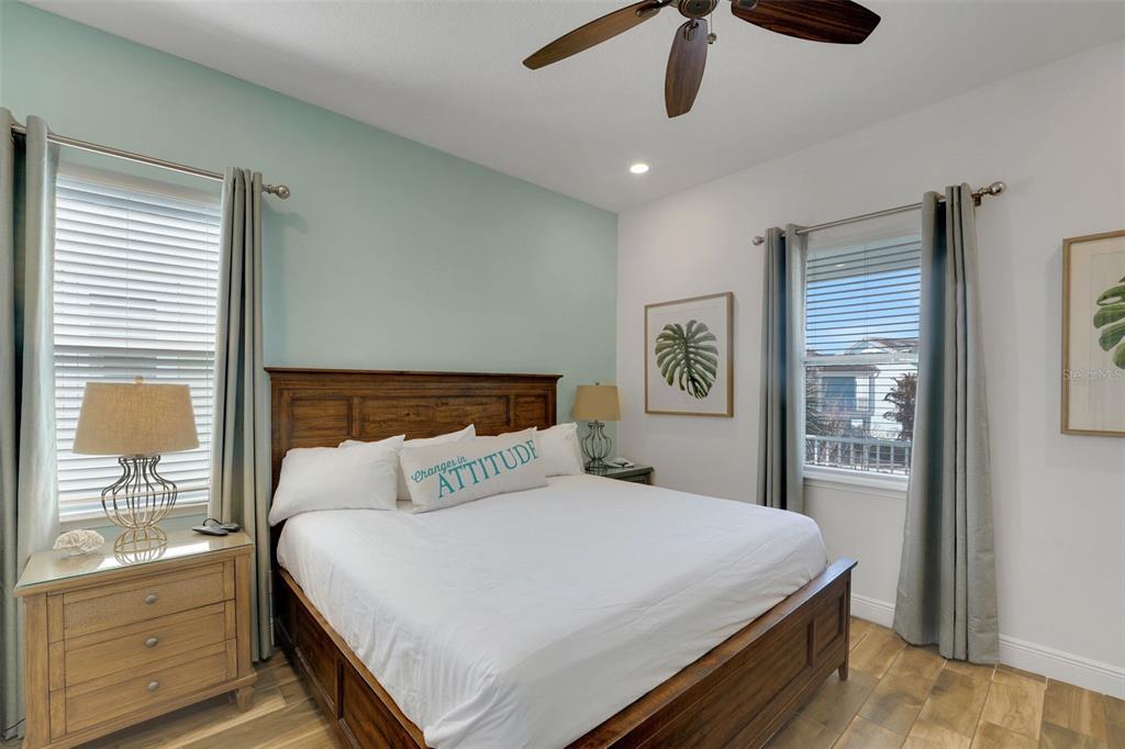 2968 Salted Rim Road Kissimmee, FL 34747 - Photo 17 of 86 a bedroom with a large bed and a chandelier