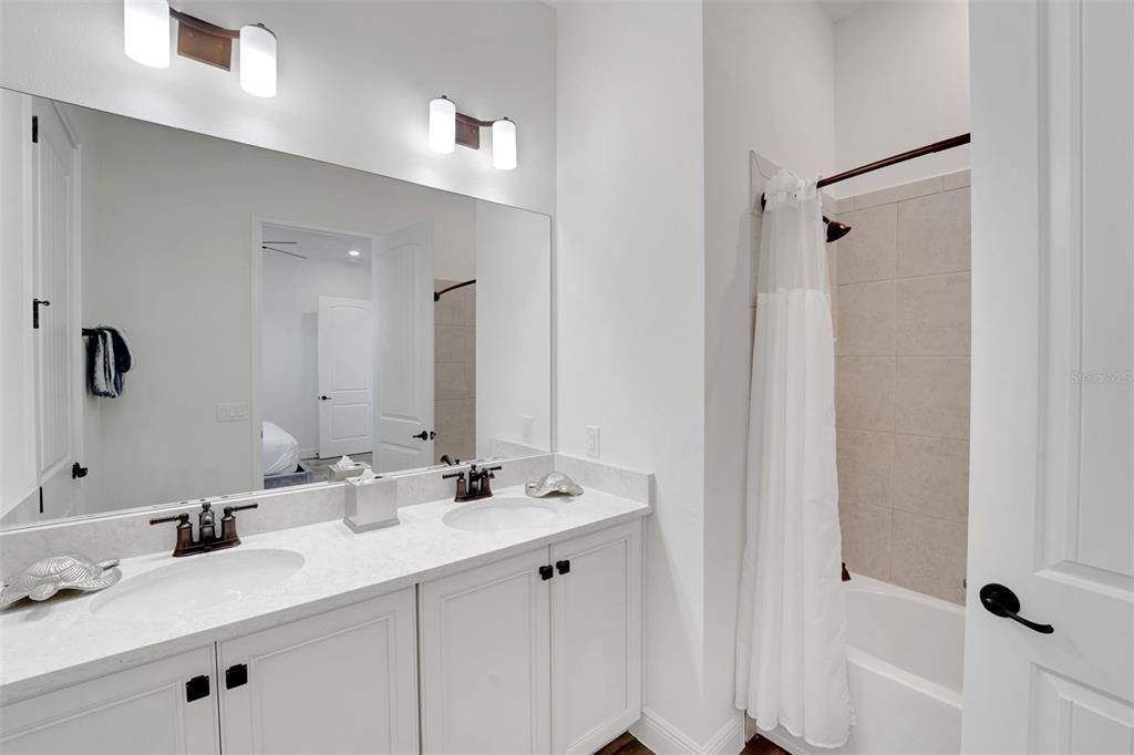 2968 Salted Rim Road Kissimmee, FL 34747 - Photo 23 of 86 a bathroom with double vanity sink a mirror and shower