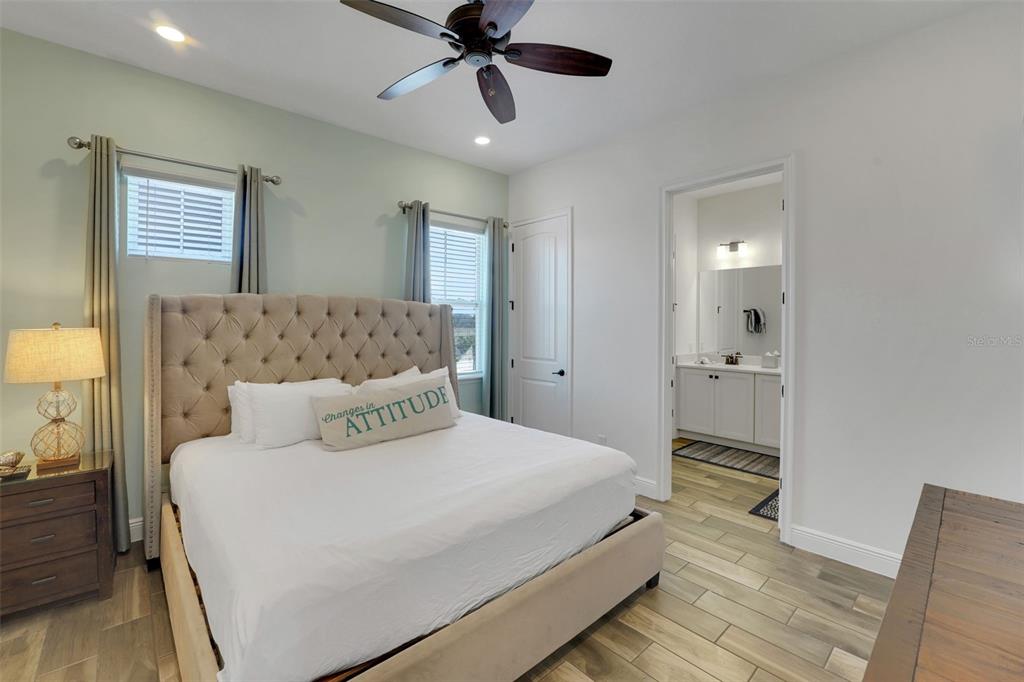 2968 Salted Rim Road Kissimmee, FL 34747 - Photo 24 of 86 a bedroom with a large bed and a chandelier