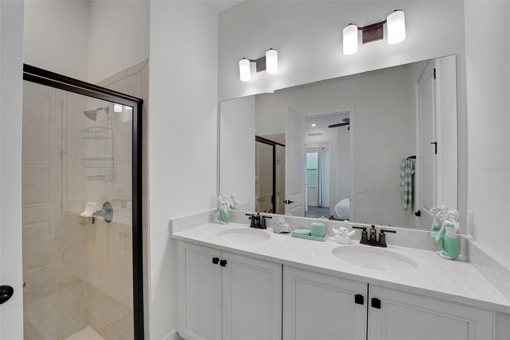 2968 Salted Rim Road Kissimmee, FL 34747 - Photo 26 of 86 a bathroom with a sink and a mirror