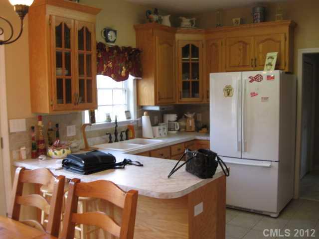 3601 Haigler Road Monroe, NC 28110 - Photo 8 of 14 a kitchen with a refrigerator a stove a sink and a refrigerator