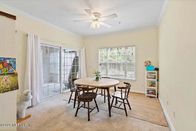 a dining room with furniture and window
