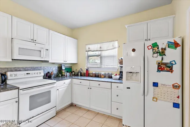 a kitchen with cabinets appliances and cabinets