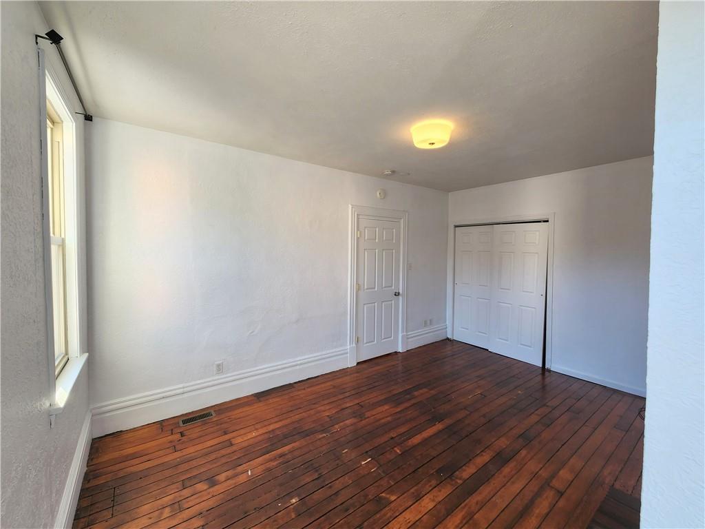 5330 Butler Street, Unit LOFT Pittsburgh, PA 15201 - Photo 4 of 6 an empty room with wooden floor and windows