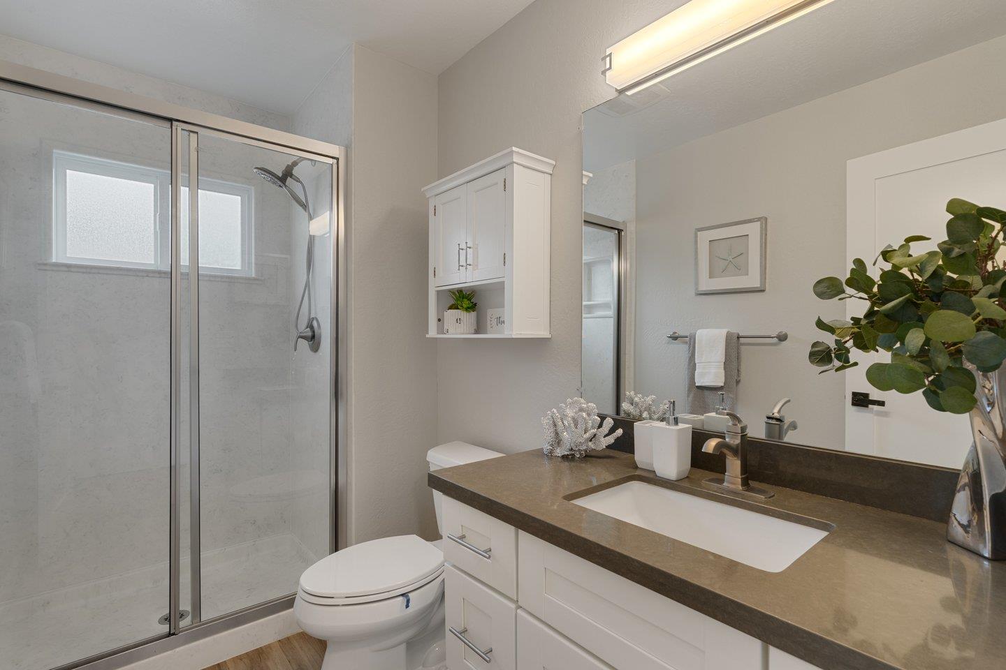 2425 Whitethorne Drive San Jose, CA 95128 - Photo 32 of 48 a bathroom with a granite countertop sink a toilet and a mirror