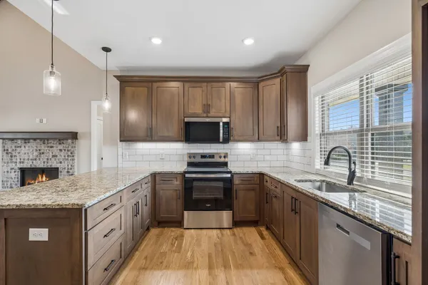 a kitchen with a sink stove and cabinets
