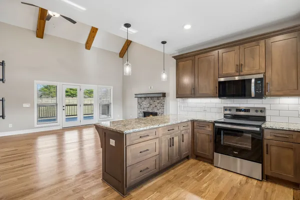 a kitchen with stainless steel appliances granite countertop a stove and a sink